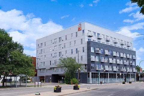 A large white building with a red logo on the top left corner.