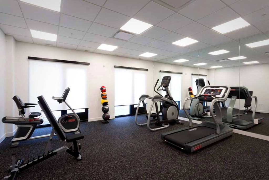 a gym with various exercise equipment in a large room