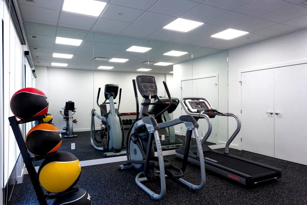 a gym with cardio equipment in a break room