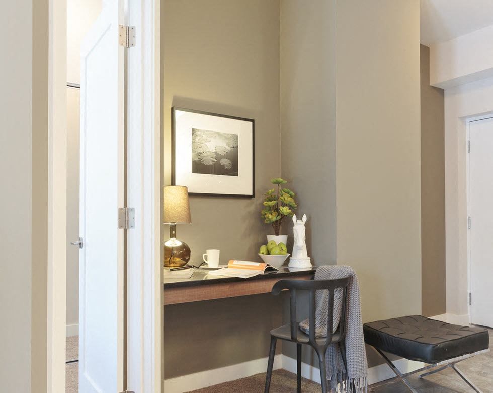 a desk and a chair in a room with a door