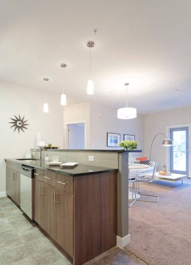a kitchen with an island in the middle of a living room