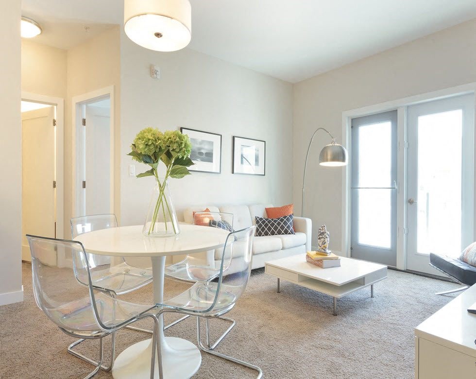 a living room with a table and chairs