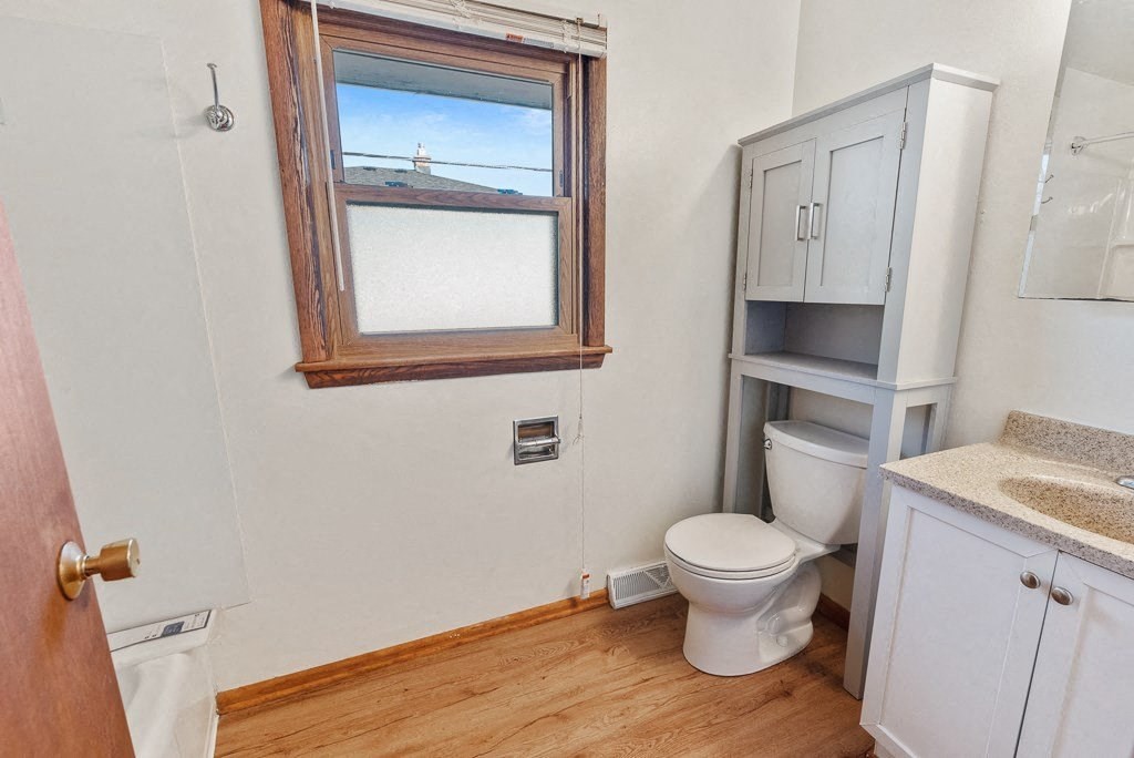 a bathroom with a toilet and a window