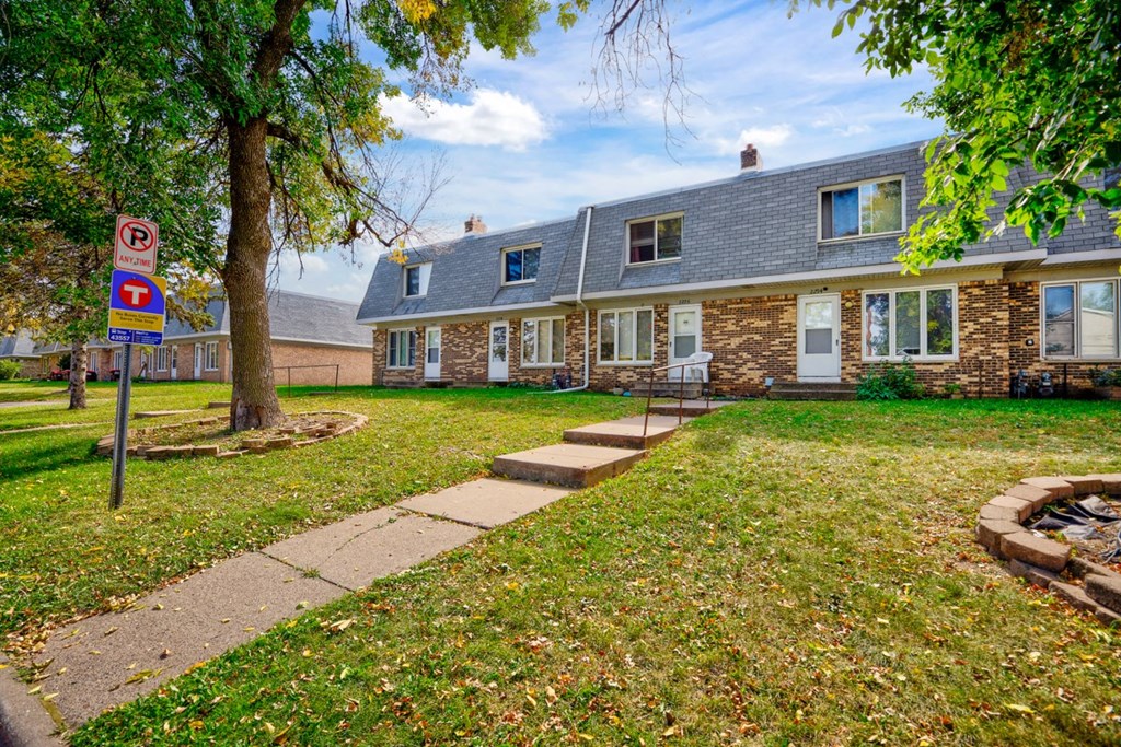 a house with a yard and a no parking sign