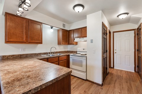 a kitchen with white appliances and wooden cabinets
