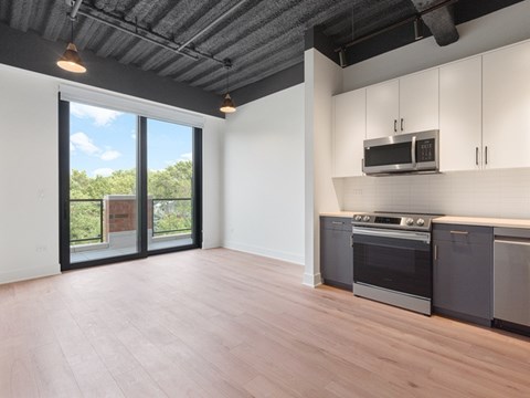 A kitchen with a stove top oven and microwave.