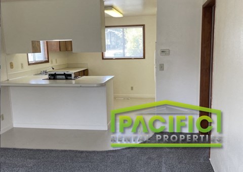 a description of a kitchen in a house with a green logo