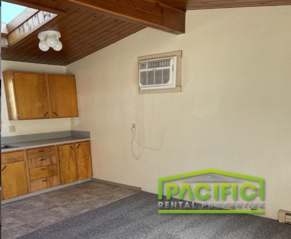 a kitchen with an air conditioning unit on the wall