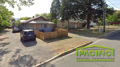 a car parked on a street in front of a house