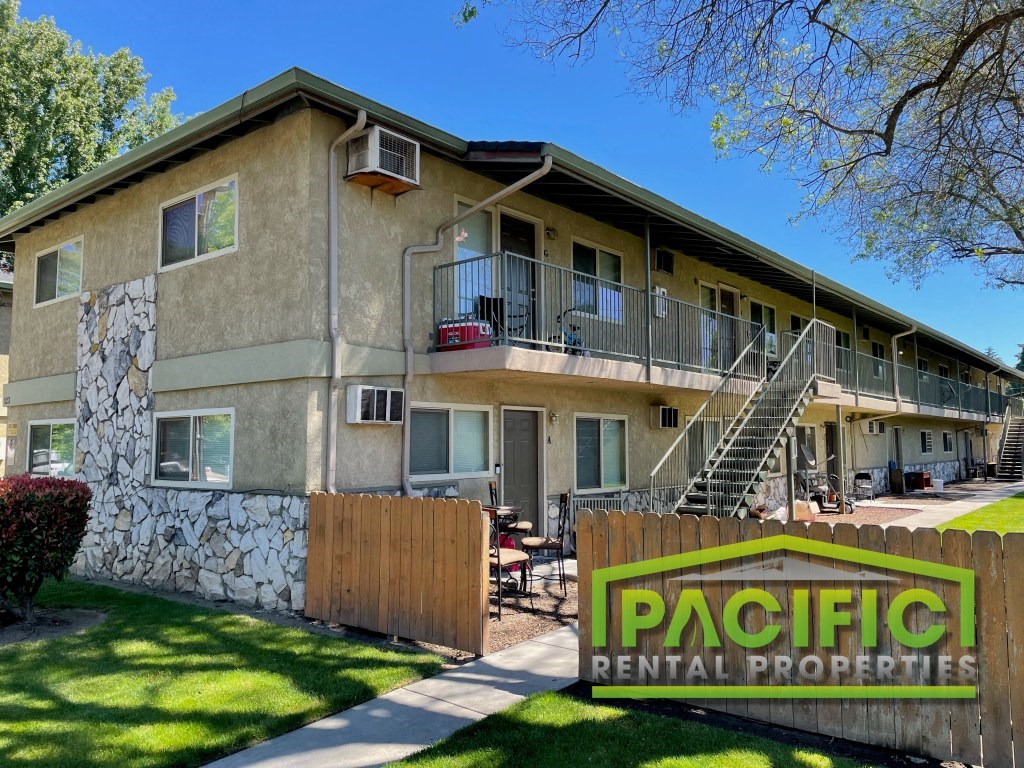 a building with a pacific rental properties sign in front of it
