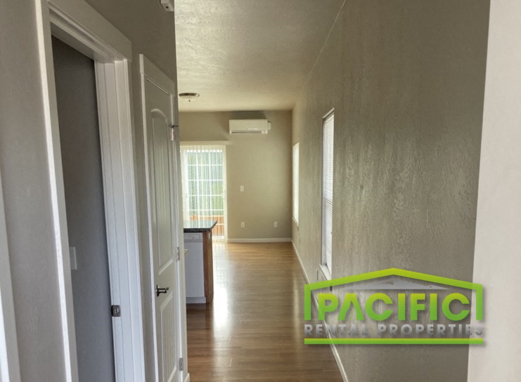 the living room and hallway of an empty house
