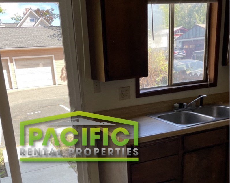 a small kitchen with a sink and a window