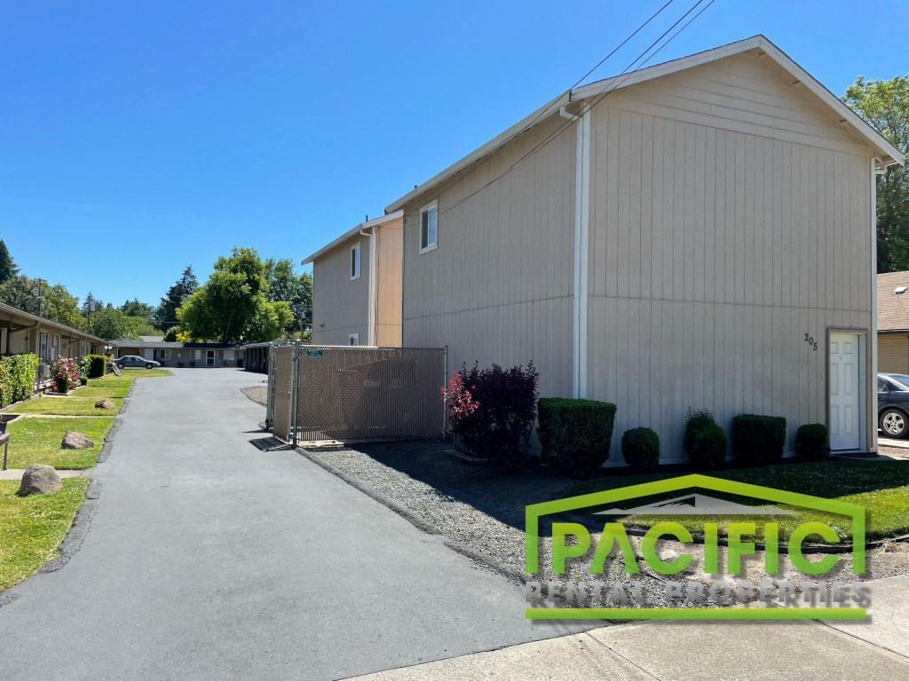 a large white building with a street in front of it