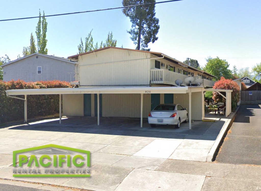 a car parked under a roof in front of a house