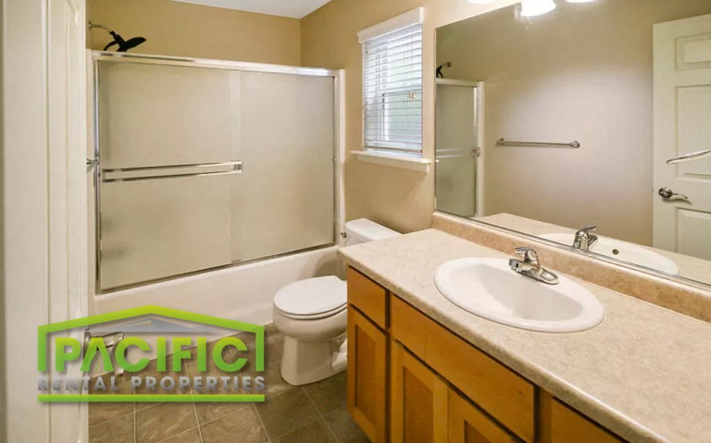 a bathroom with a sink toilet and a shower