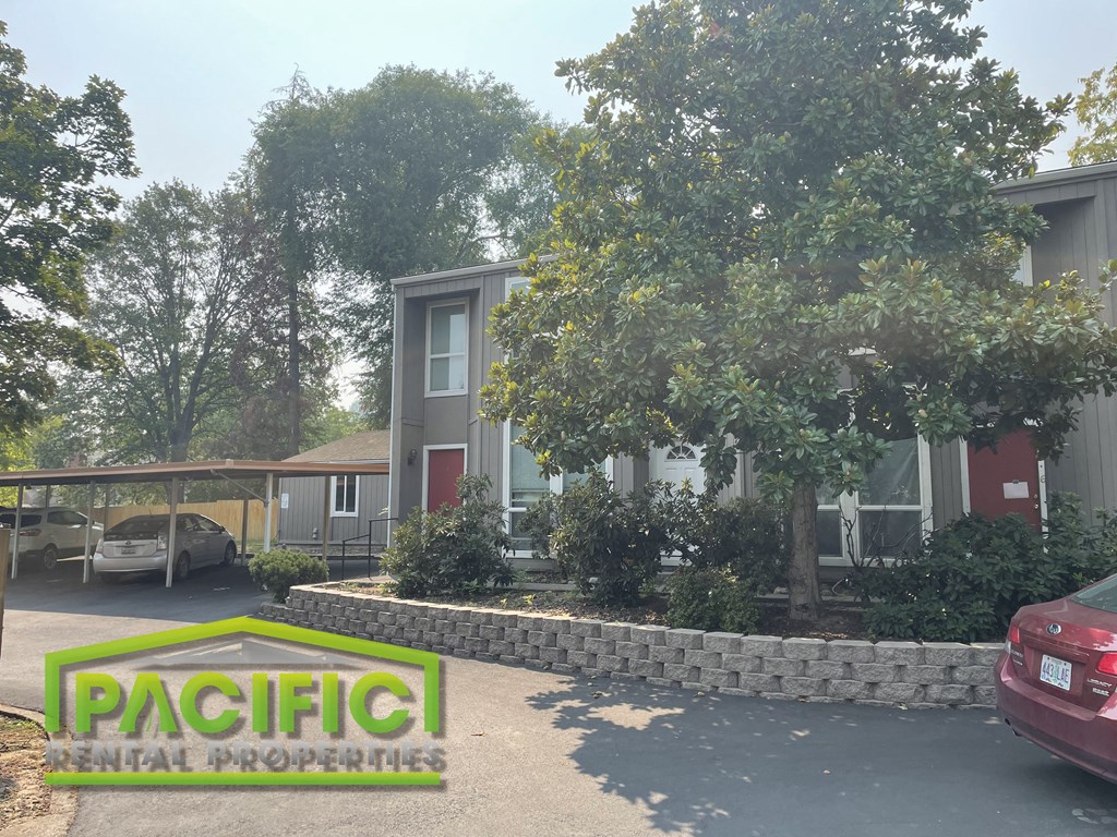 a view of the pacific residential properties logo in front of a house
