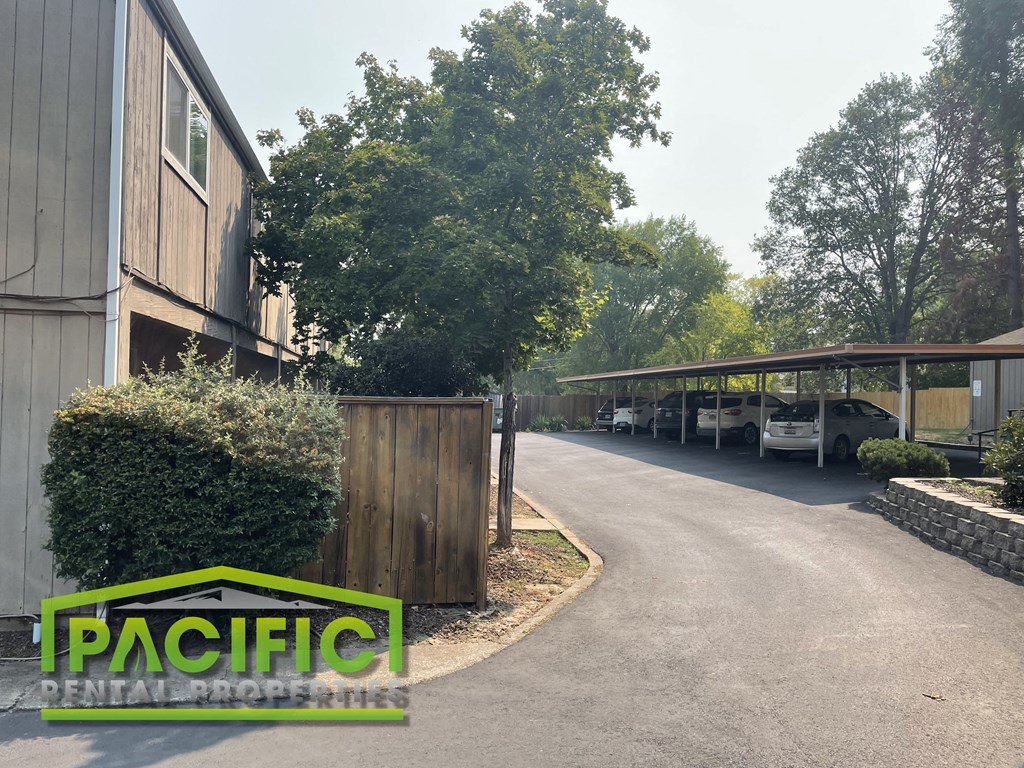 a parking lot with cars parked in front of a building