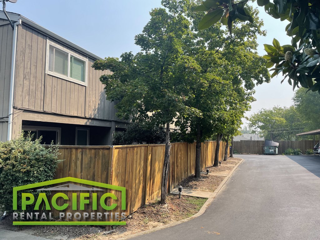 a wooden fence in front of a house