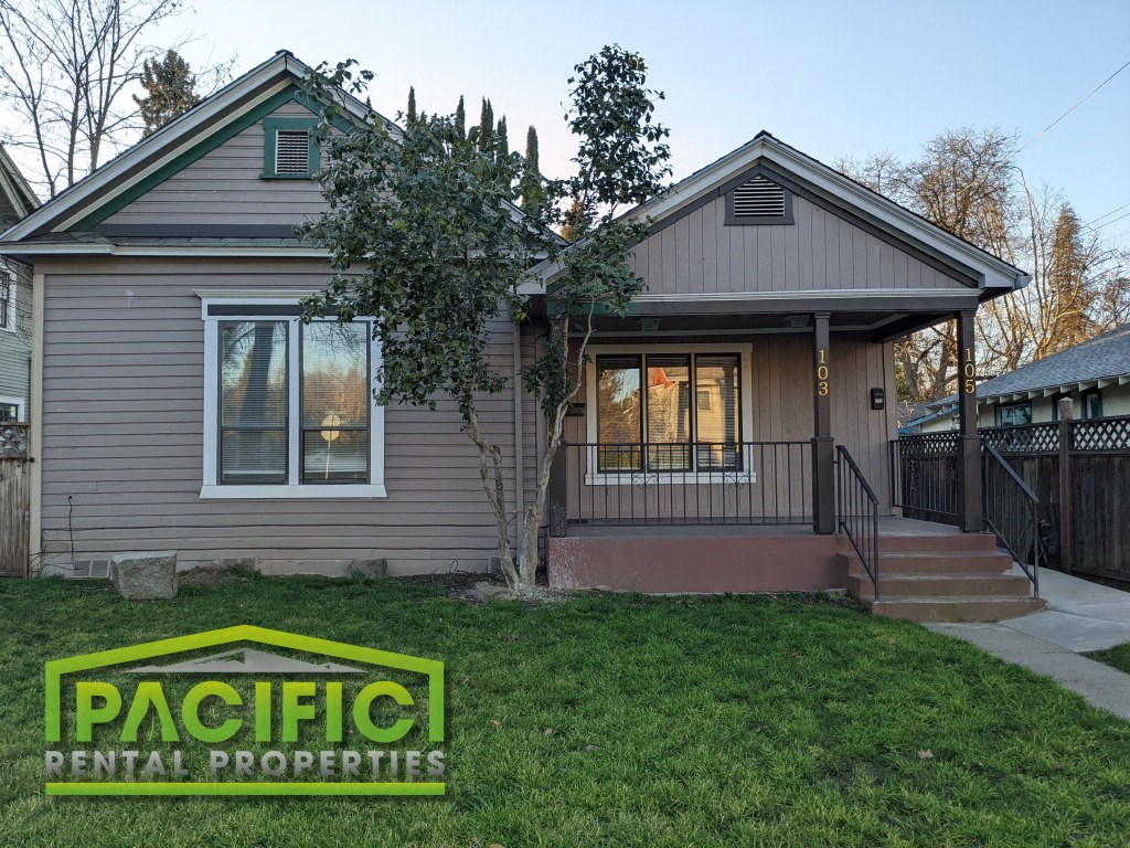 a remodeled house with a front yard and grass