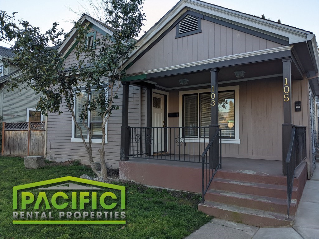 the front of a house with a porch and a pacific rental properties logo