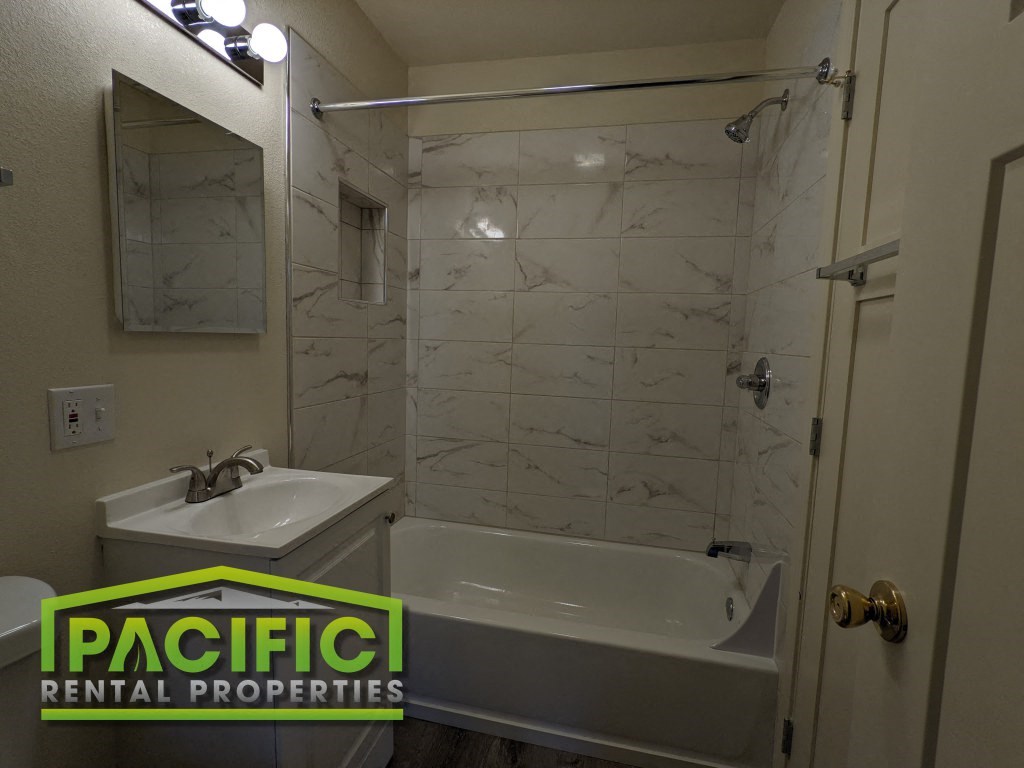 a small bathroom with a tub and a sink