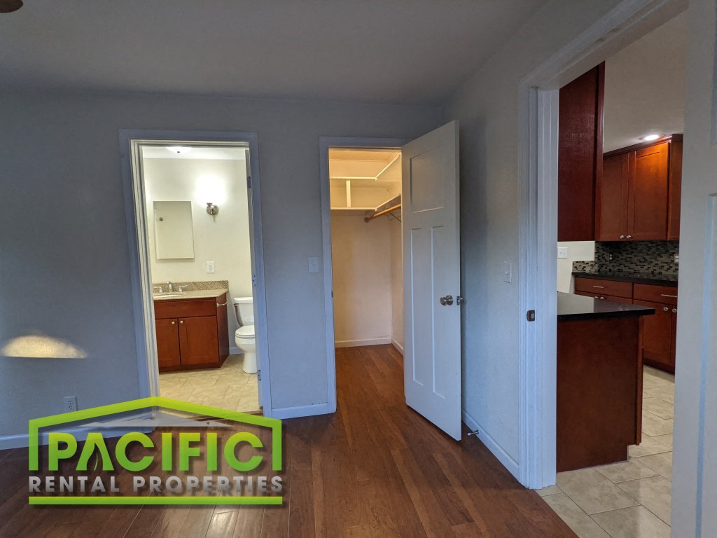 a pass through between two doors into a kitchen and a bathroom