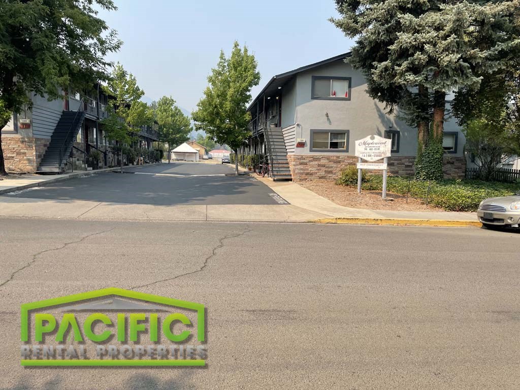 an empty street with a house on the side of it