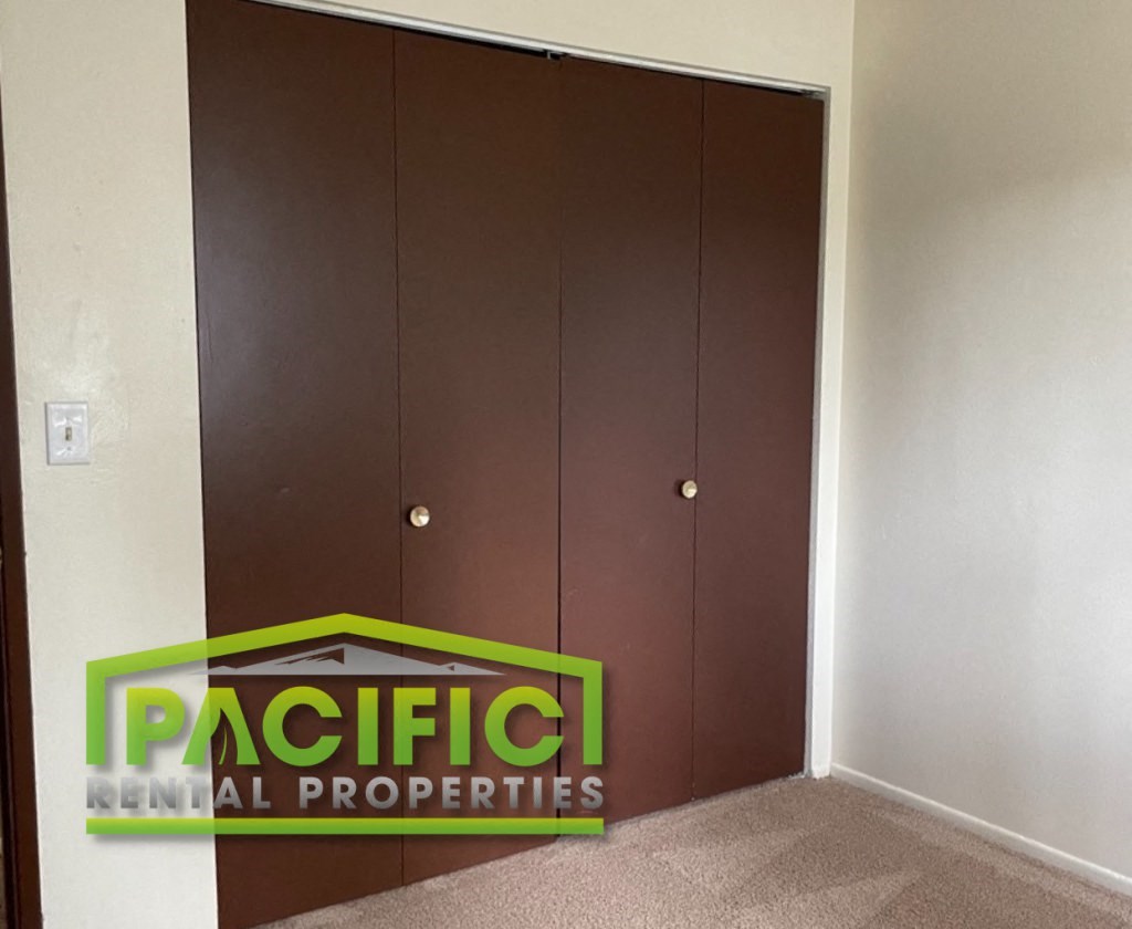 a door to a room with a pacific national properties logo on it