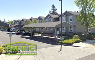 a parking lot in front of a row of houses