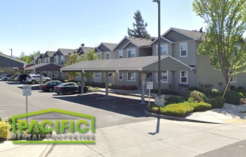 a parking lot in front of a row of houses