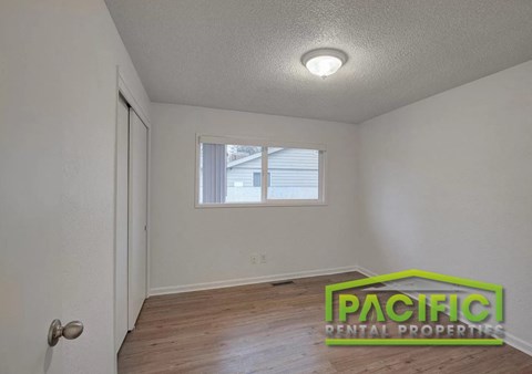 A room with a window and a door is shown with a logo for Pacific Rental Properties.