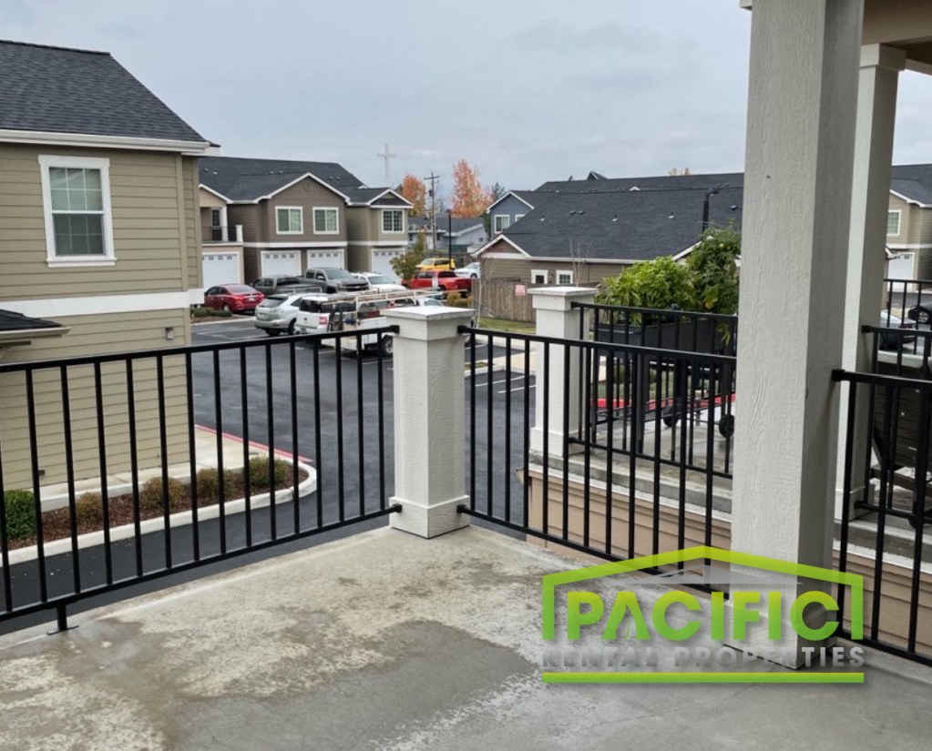 a view from the balcony of a home with a black iron fence