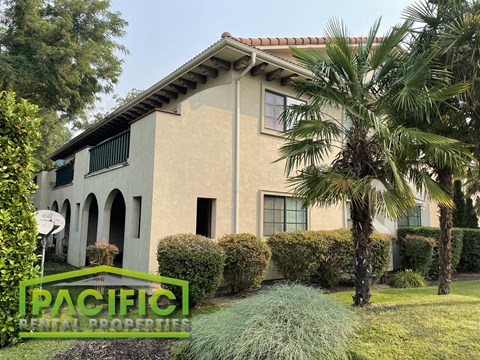 a house with palm trees in front of it