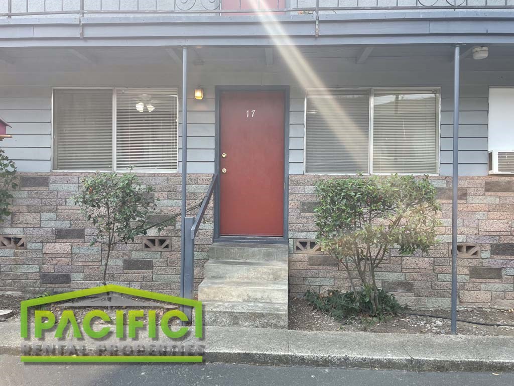the front of a house with a red door