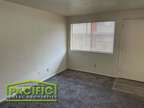 an empty room with a window and a door
