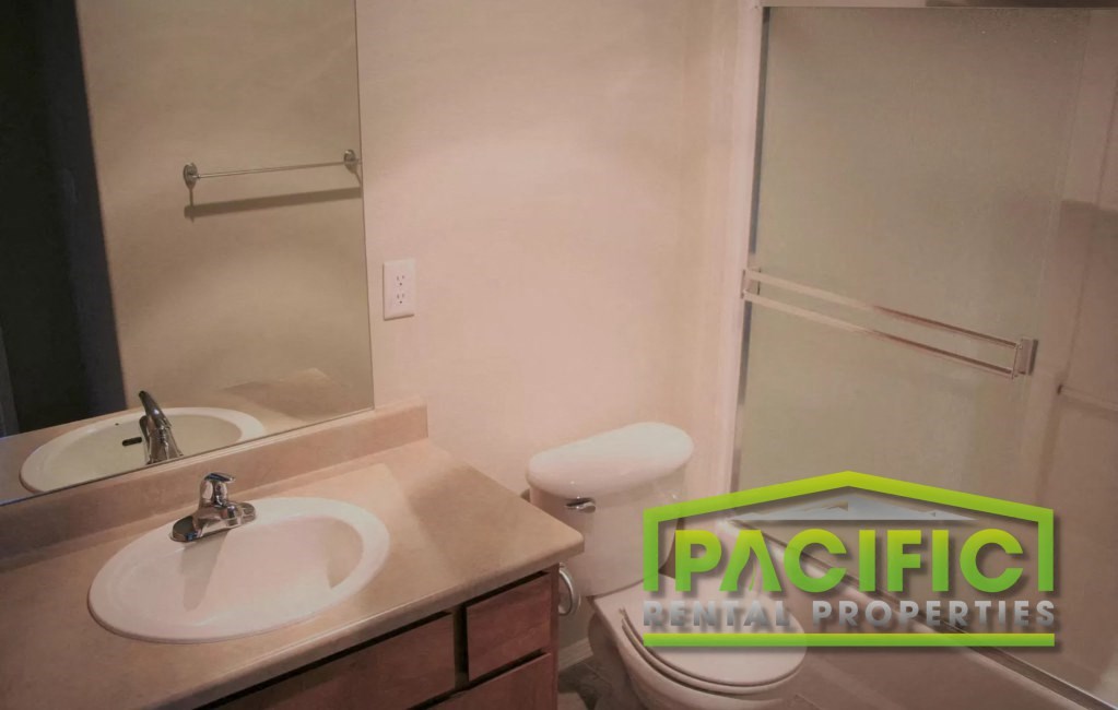 a bathroom with a sink and a toilet and a shower