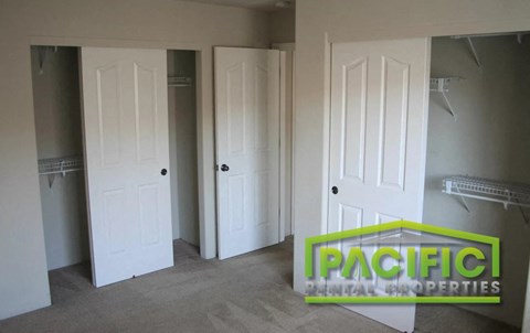 a room with three closets and three doors