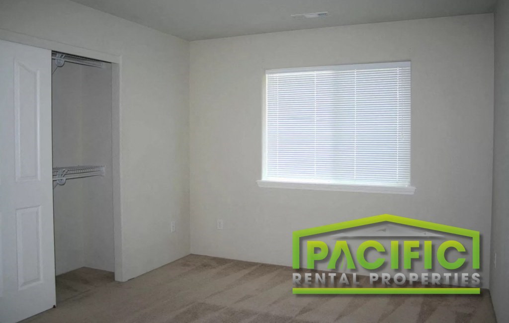 the interior of a room with a closet and a window