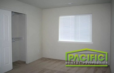 the interior of a room with a closet and a window