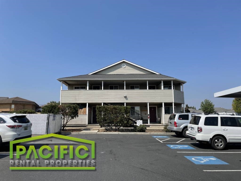 a building with cars parked in a parking lot