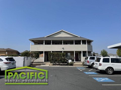 a building with cars parked in a parking lot