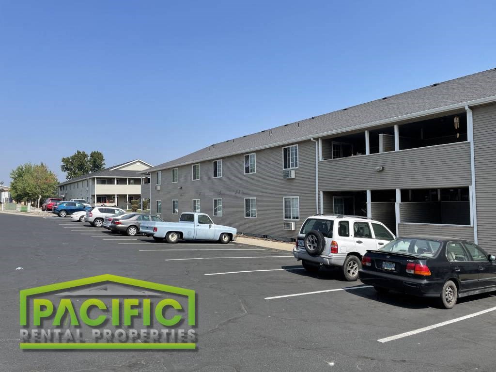 a parking lot with cars in front of a building