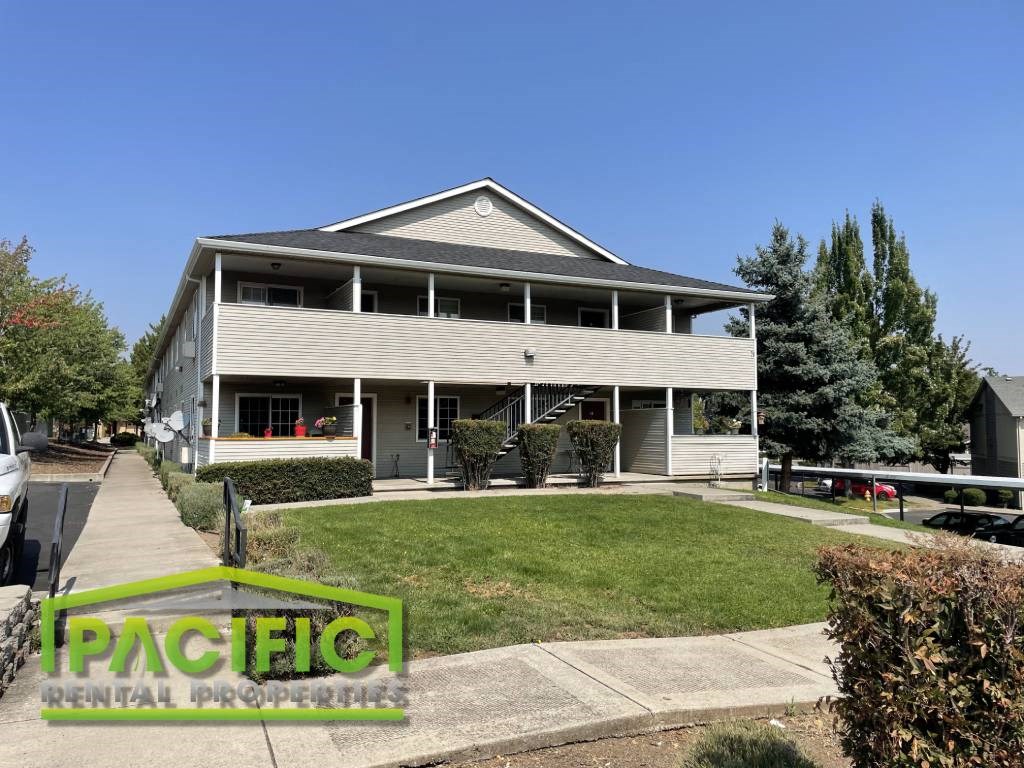 a white house with a lawn and a sidewalk