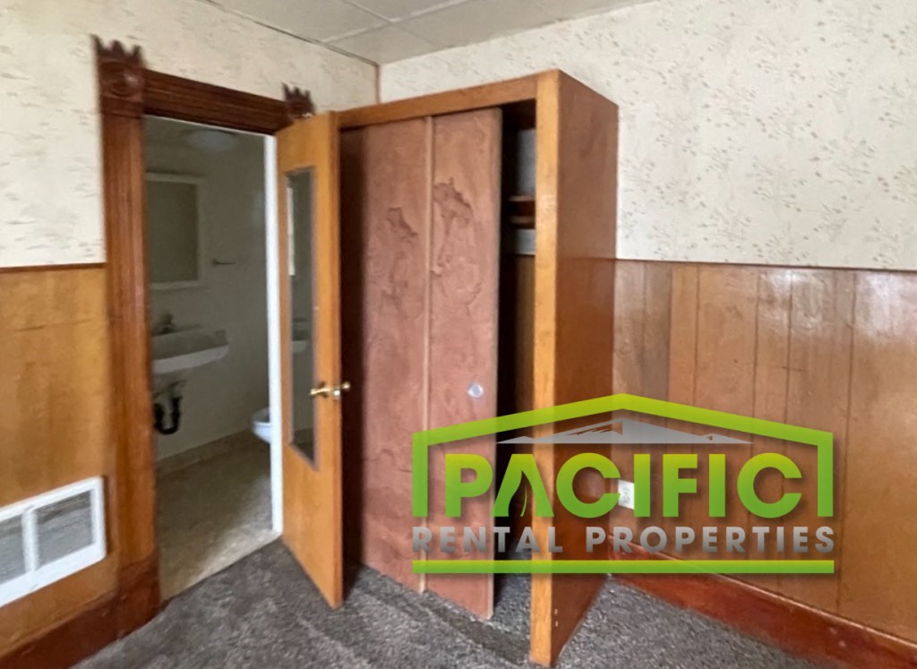 a small room with a door open to a bathroom