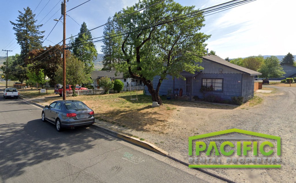a car parked on the street in front of a house
