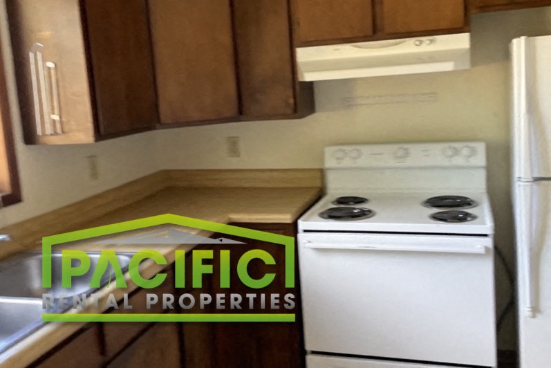 a kitchen with a stove and a refrigerator in it