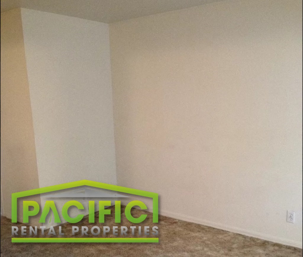 a corner of a room with a sign on the floor