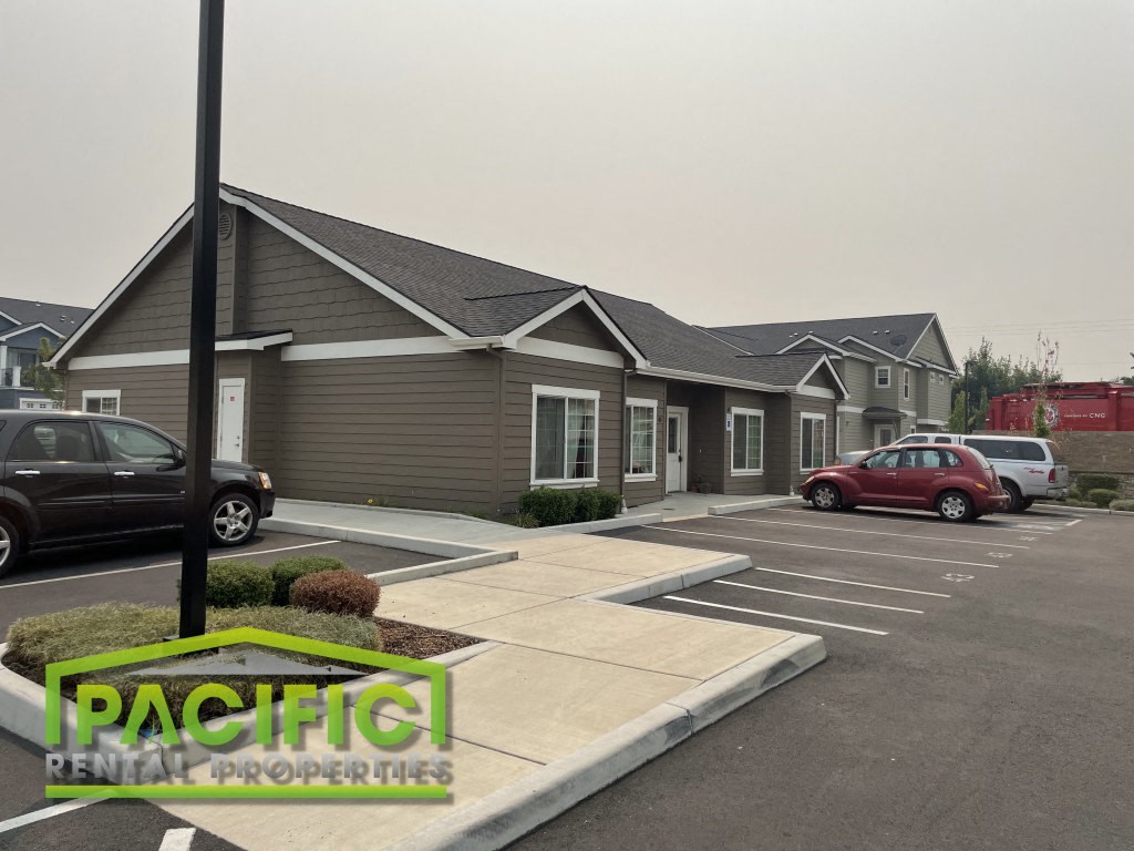 a parking lot with cars in front of a house