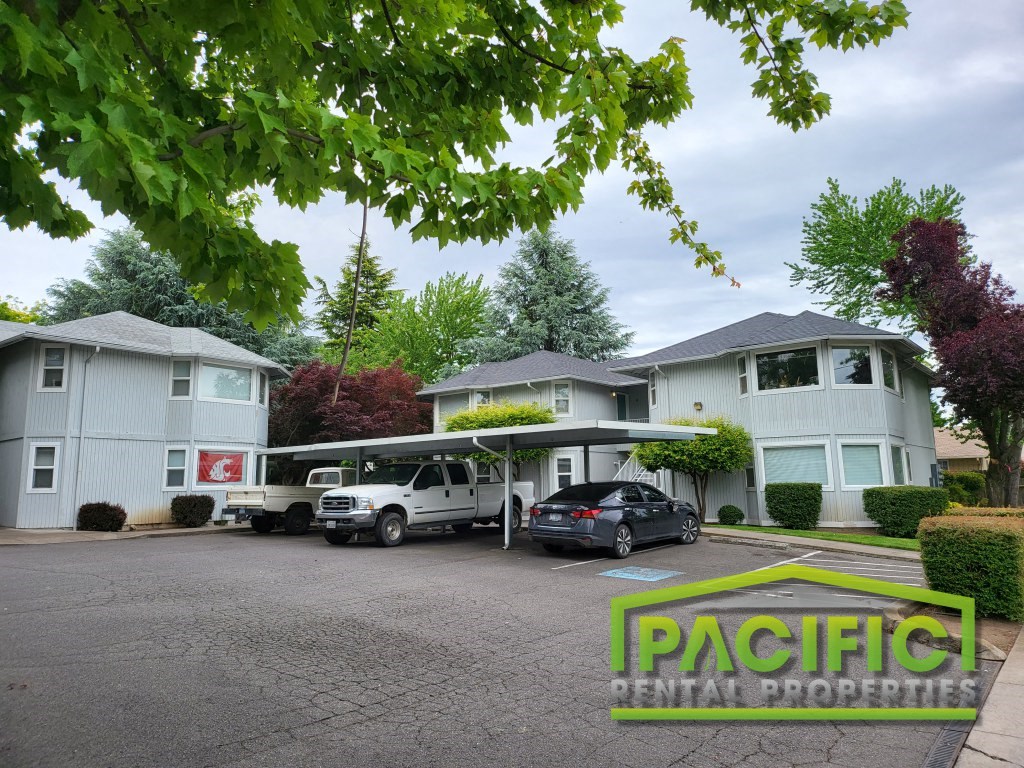 a suburban house with a parking lot and cars in front of it