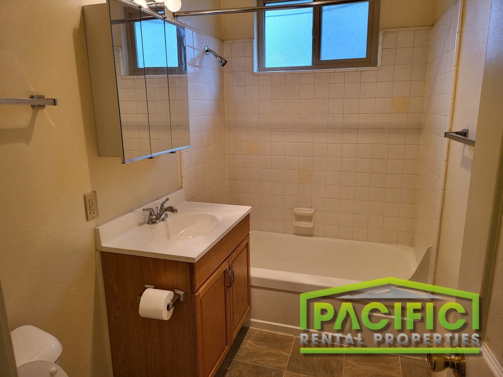 a small bathroom with a sink and a bath tub